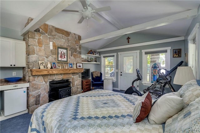 bedroom featuring lofted ceiling with beams, multiple windows, ceiling fan, and carpet