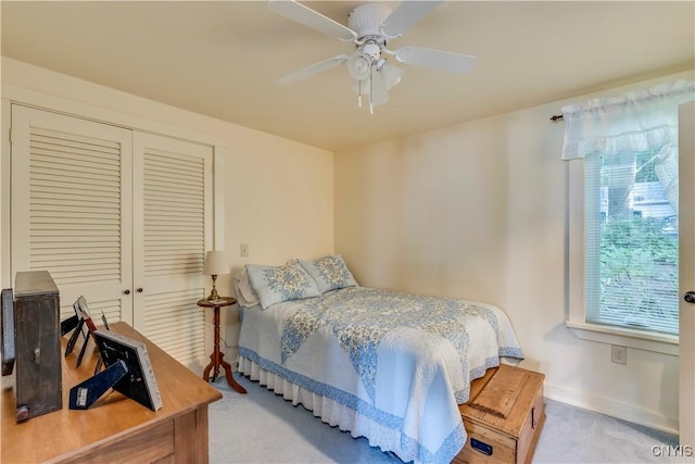 carpeted bedroom featuring a ceiling fan, baseboards, and a closet