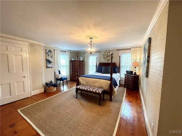bedroom featuring hardwood / wood-style flooring, an inviting chandelier, and crown molding