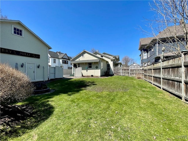 view of yard featuring fence and a residential view