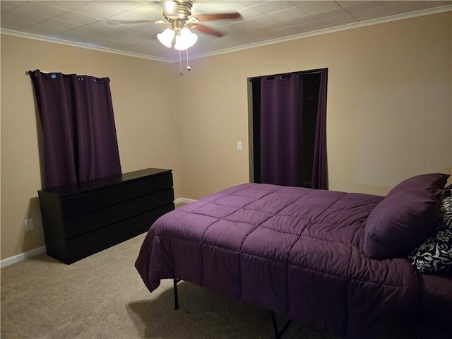 carpeted bedroom with ceiling fan, baseboards, and ornamental molding