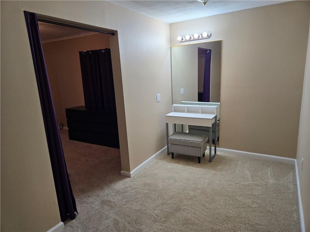 hallway with carpet and baseboards