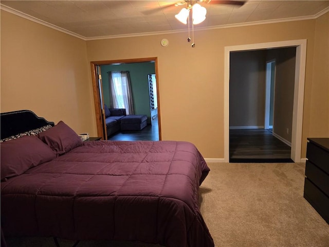carpeted bedroom with a ceiling fan, baseboards, and ornamental molding