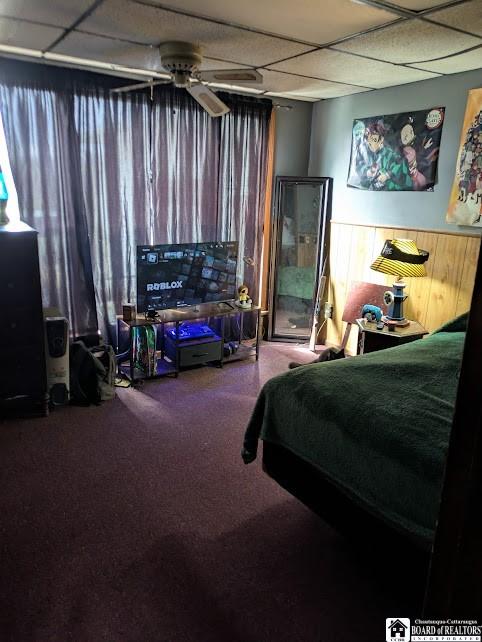 carpeted bedroom with a paneled ceiling