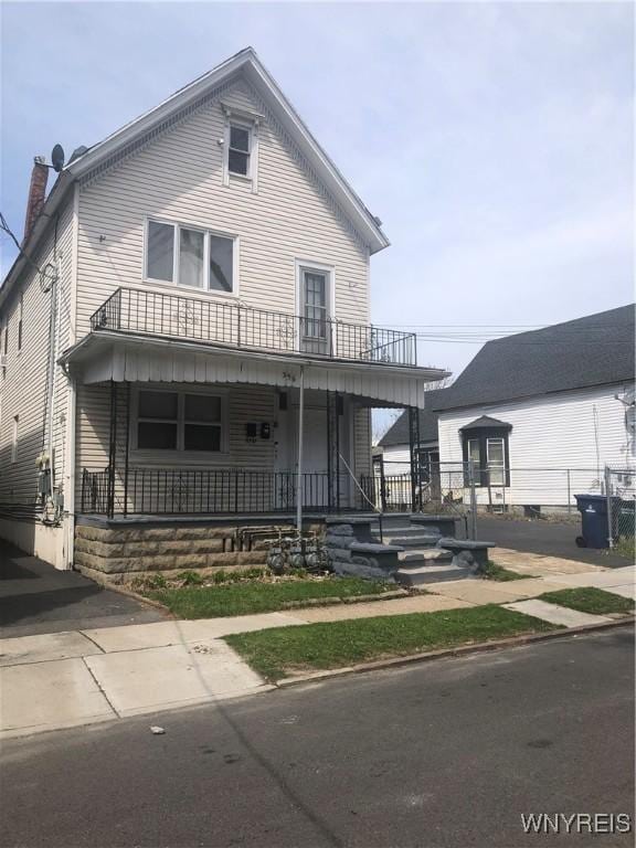396 Guilford St, Buffalo, NY 14211 - view of front of home with a porch, a chimney, and a balcony