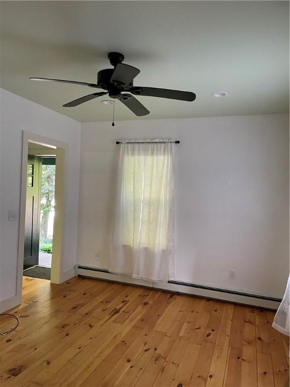 10 Orchard St Unit 8, Urbana, NY 14840 - empty room with light wood-type flooring, ceiling fan, and baseboard heating