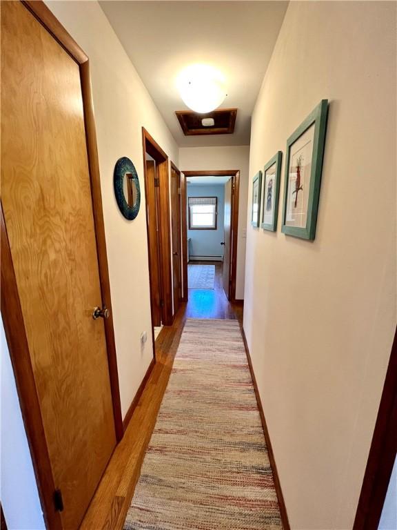 3460 County Road 28, Reading, NY 14891 - corridor with baseboards, wood finished floors, and a baseboard radiator