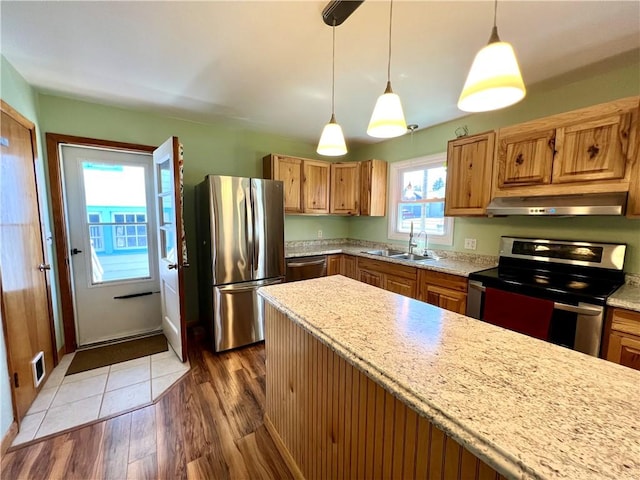 3460 County Road 28, Reading, NY 14891 - kitchen with stainless steel appliances, a sink, range hood, and hanging light fixtures