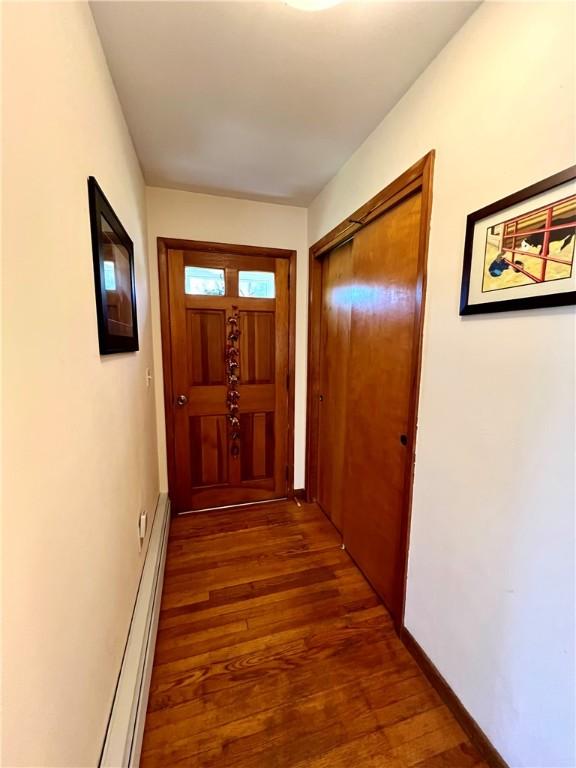 3460 County Road 28, Reading, NY 14891 - doorway to outside with baseboards, wood finished floors, and baseboard heating