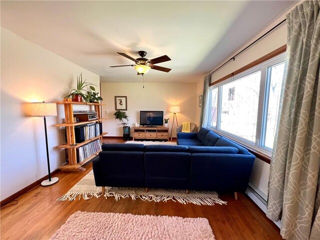 3460 County Road 28, Reading, NY 14891 - living room with baseboards, baseboard heating, wood finished floors, and a ceiling fan