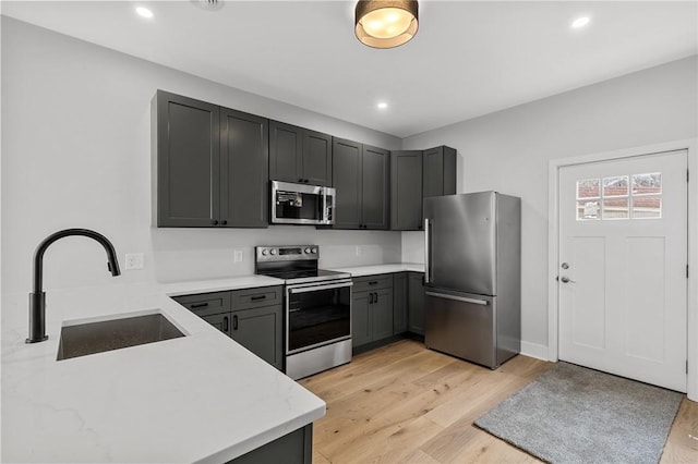 169 S Union St, Rochester, NY 14607 - kitchen featuring recessed lighting, stainless steel appliances, light wood finished floors, and a sink