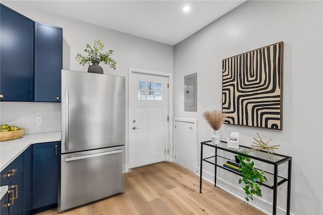 doorway to outside featuring electric panel and light wood-style flooring