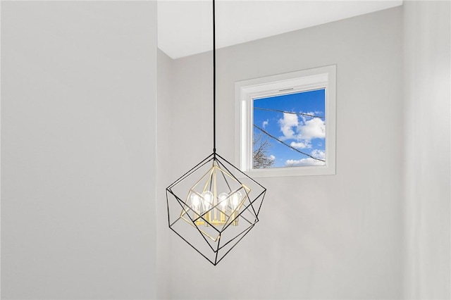 interior details featuring an inviting chandelier