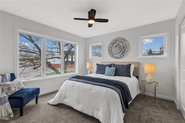 carpeted bedroom featuring a ceiling fan and baseboards