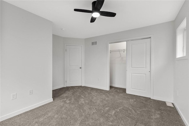 unfurnished bedroom with baseboards, carpet, a closet, and ceiling fan