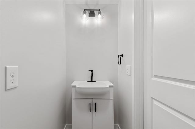 bathroom featuring baseboards and vanity