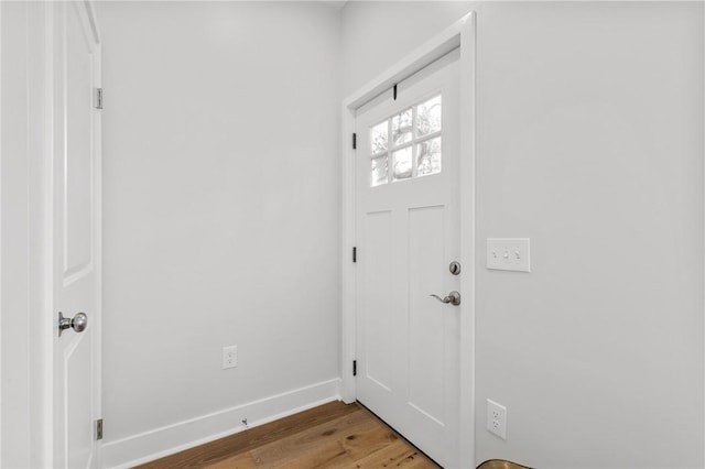 foyer featuring light wood-style flooring and baseboards