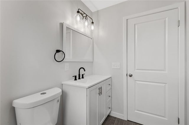 bathroom featuring toilet and vanity