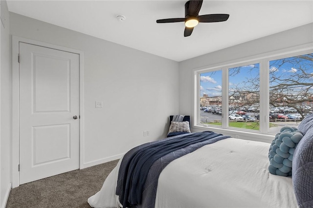 carpeted bedroom featuring a ceiling fan and baseboards