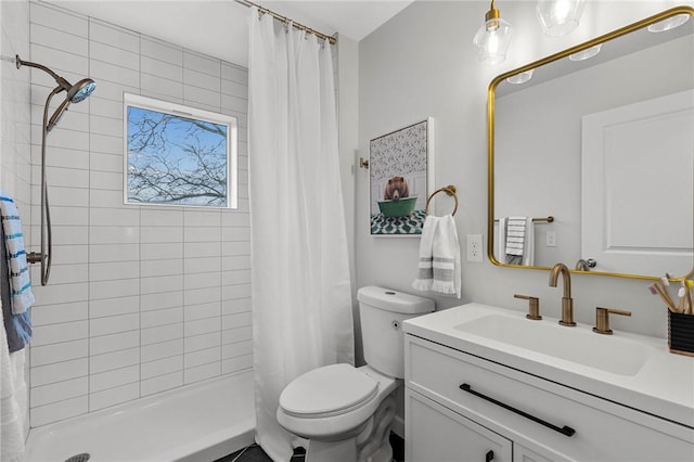 full bathroom with vanity, a shower stall, and toilet