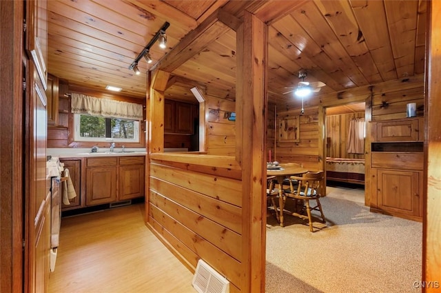 kitchen featuring wooden ceiling, rail lighting, visible vents, and light countertops