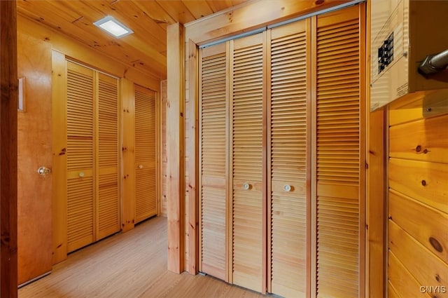 hallway with wood ceiling and light wood-style floors