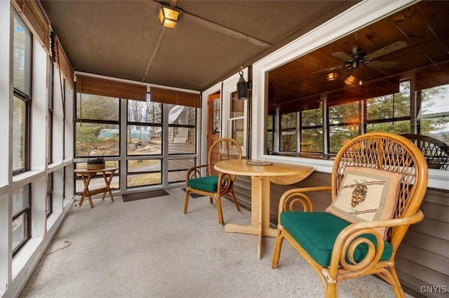 sunroom / solarium featuring a wealth of natural light and a ceiling fan