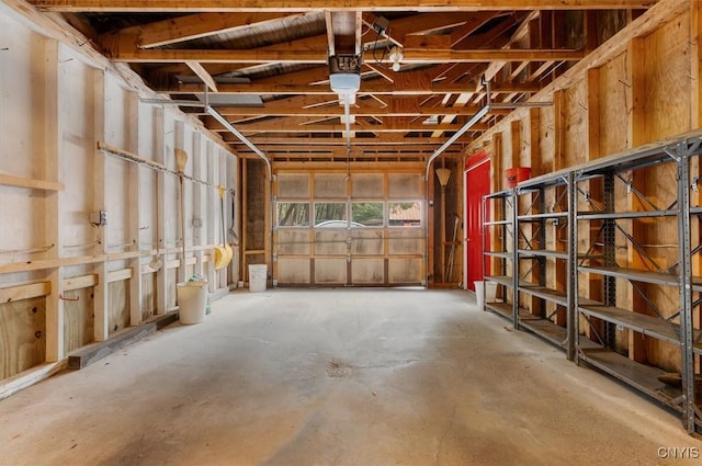 miscellaneous room featuring a garage, a ceiling fan, and concrete floors