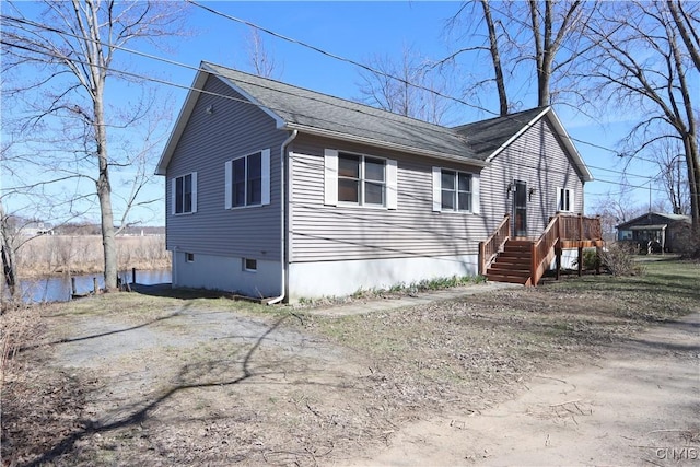 14 Renshaw Bay Rd, Sandy Creek, NY 13145 - view of front of house with a shingled roof and a water view