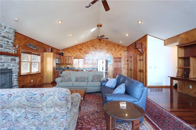 14 Renshaw Bay Rd, Sandy Creek, NY 13145 - living room featuring a ceiling fan, wood walls, and vaulted ceiling