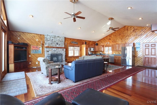 14 Renshaw Bay Rd, Sandy Creek, NY 13145 - living room with lofted ceiling, wood walls, and ceiling fan