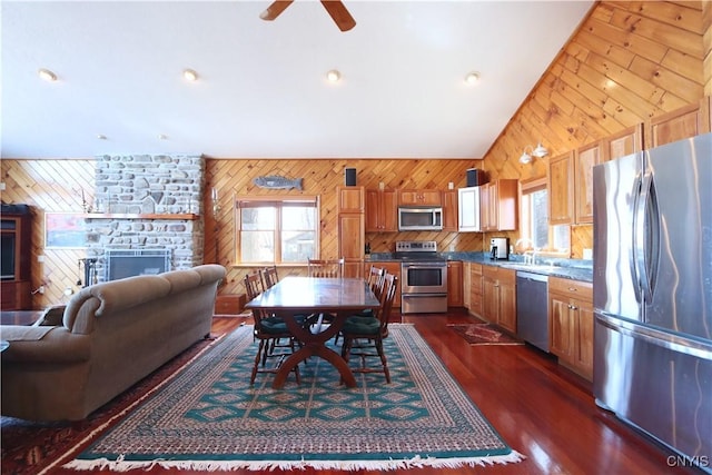 14 Renshaw Bay Rd, Sandy Creek, NY 13145 - dining space featuring dark wood finished floors, wooden walls, vaulted ceiling, and ceiling fan
