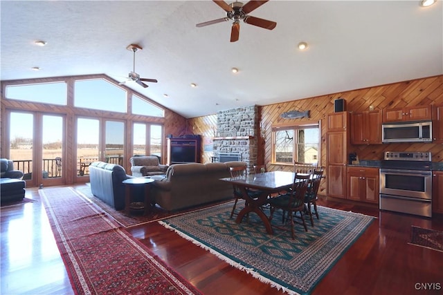 14 Renshaw Bay Rd, Sandy Creek, NY 13145 - dining space with wood finished floors, wood walls, high vaulted ceiling, and ceiling fan