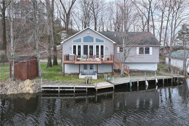 14 Renshaw Bay Rd, Sandy Creek, NY 13145 - back of property with a deck with water view and a chimney