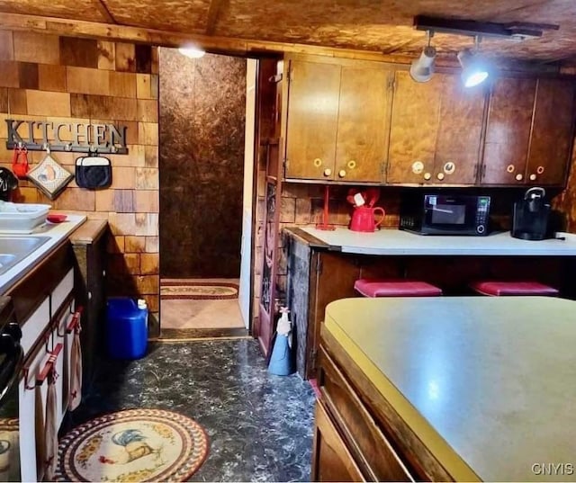 kitchen featuring black microwave and light countertops