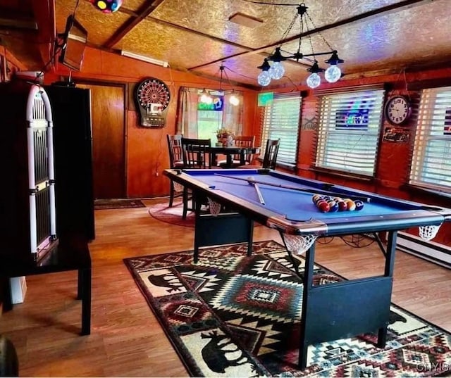 rec room with wooden walls, wood finished floors, and pool table