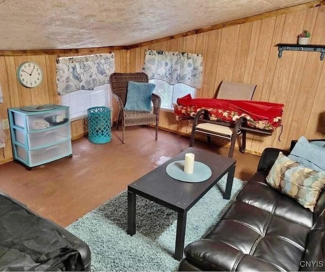 living room with a textured ceiling and wood walls
