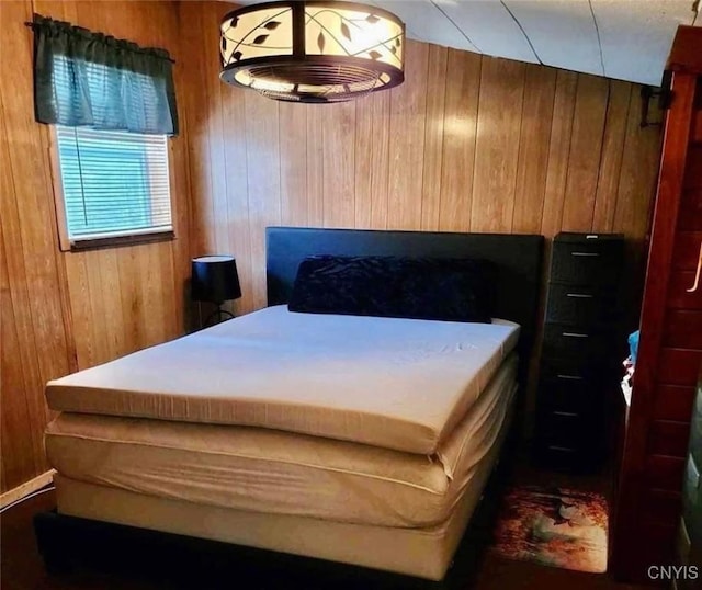 bedroom with wood walls
