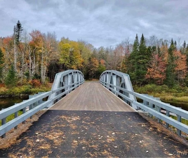 view of gate with a wooded view