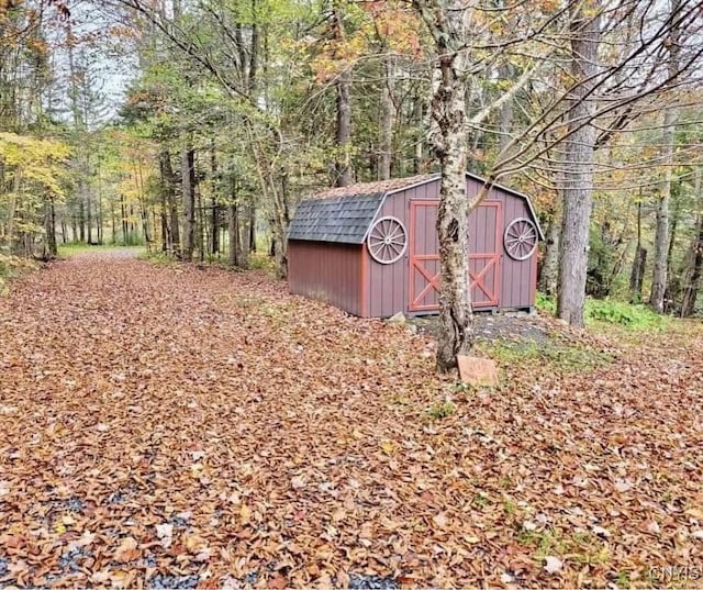 view of shed featuring a forest view