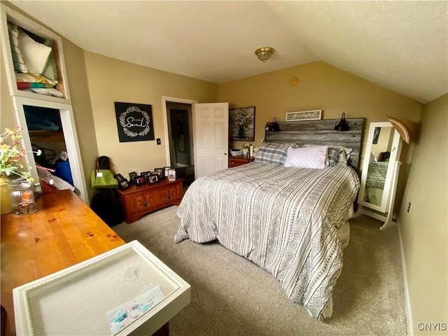 carpeted bedroom featuring vaulted ceiling