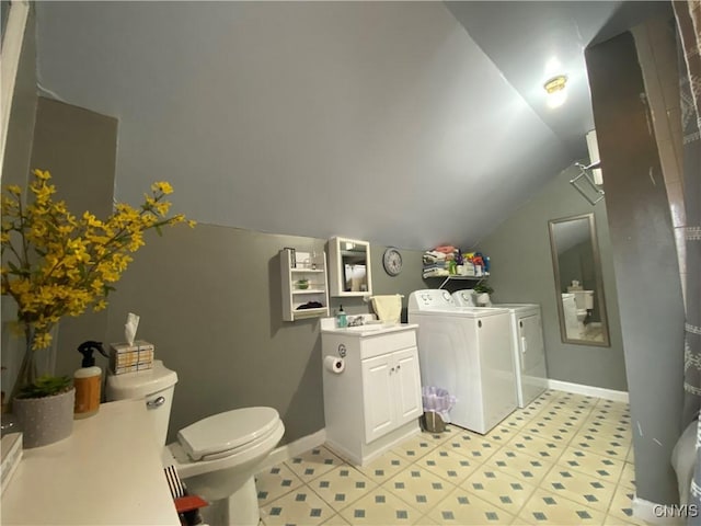 bathroom with washer and dryer, baseboards, lofted ceiling, and toilet