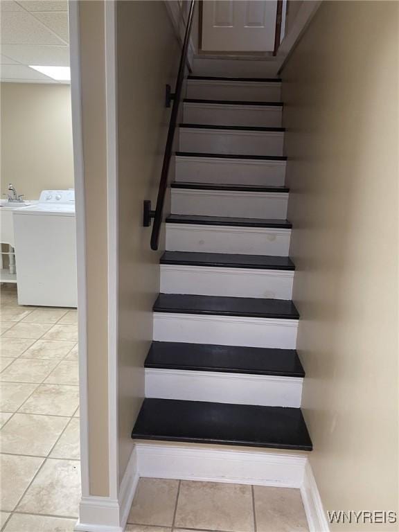 staircase with tile patterned flooring and washer / clothes dryer