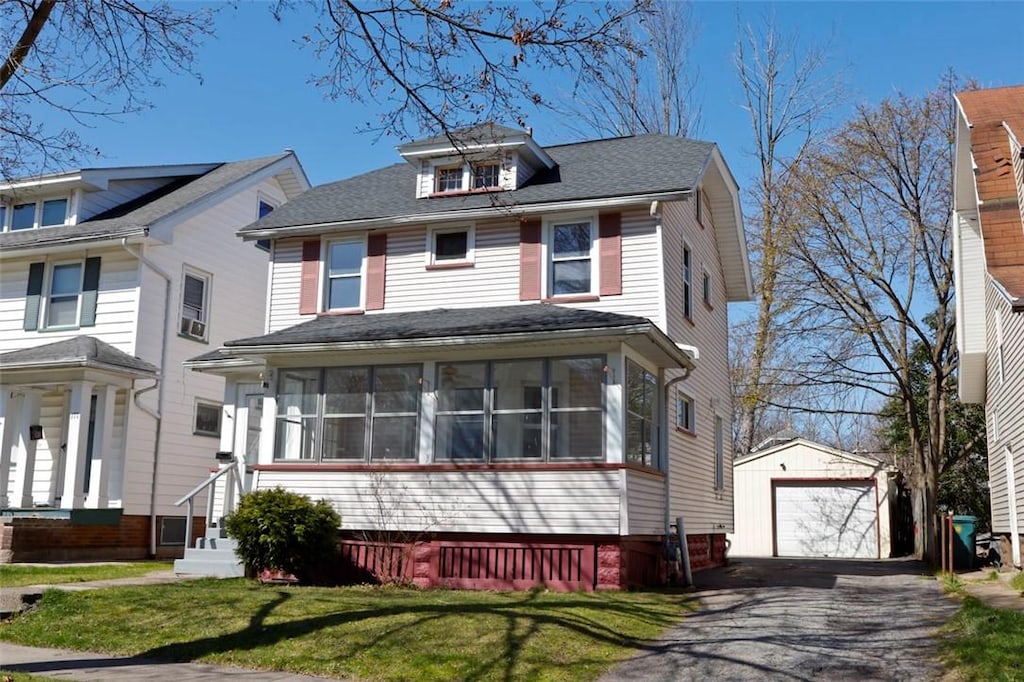 171 Salina St, Rochester, NY 14619 - traditional style home featuring aphalt driveway, roof with shingles, an outbuilding, a sunroom, and a garage