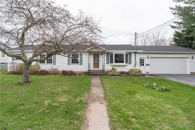 ranch-style house featuring driveway, a front yard, and a garage