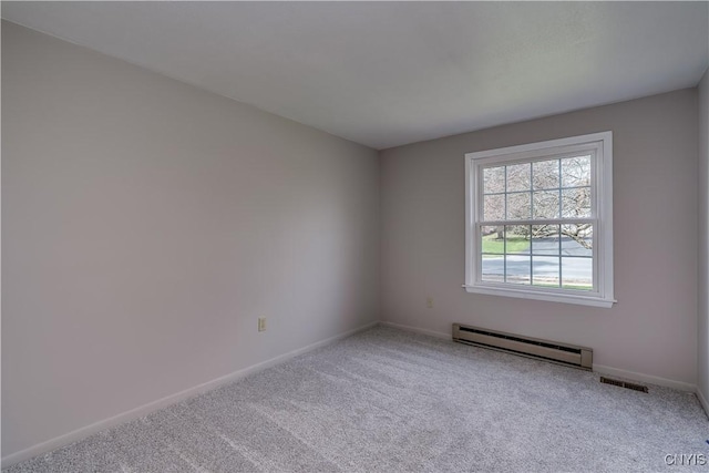 carpeted spare room featuring baseboard heating, baseboards, and visible vents