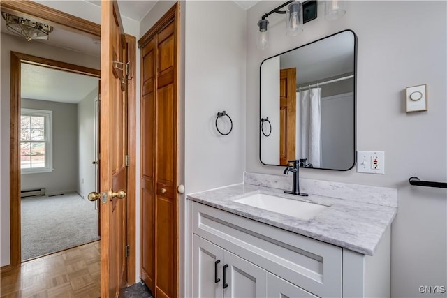 bathroom with a baseboard radiator and vanity