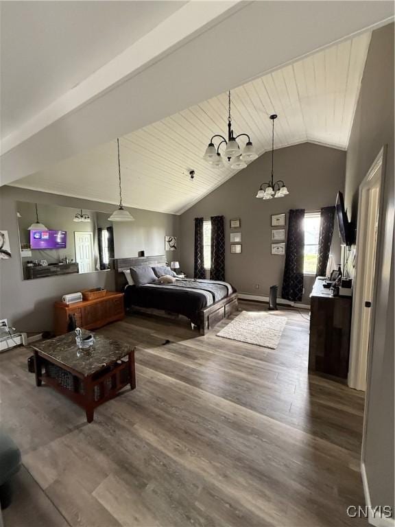 bedroom featuring vaulted ceiling, a notable chandelier, and wood finished floors