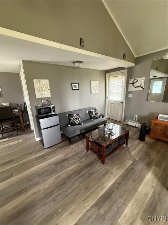 living room featuring high vaulted ceiling, a healthy amount of sunlight, and wood finished floors