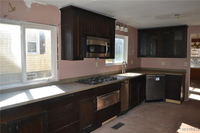 2386 Main St, Collins, NY 14034 - kitchen with dark brown cabinetry, stainless steel appliances, a sink, and a warming drawer